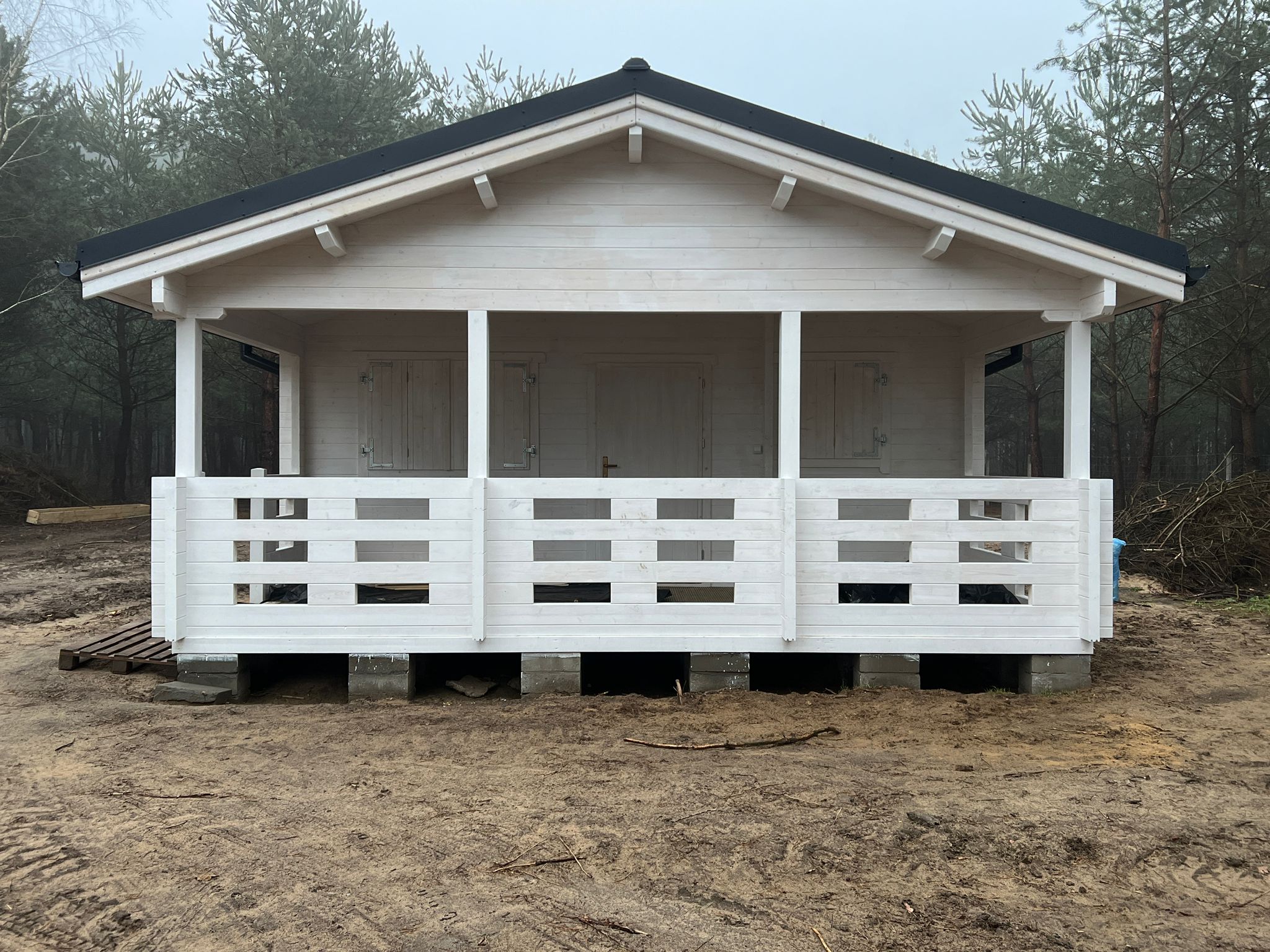 Mała, drewniana chata w lesie.