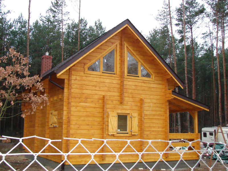 Drewniany dom z dużymi oknami.