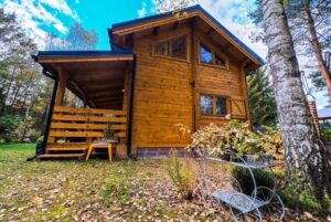 Drewniany dom na leśnej polanie.