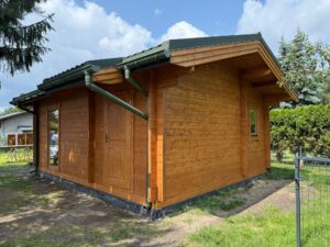 Drewniany domek w zielonym otoczeniu.